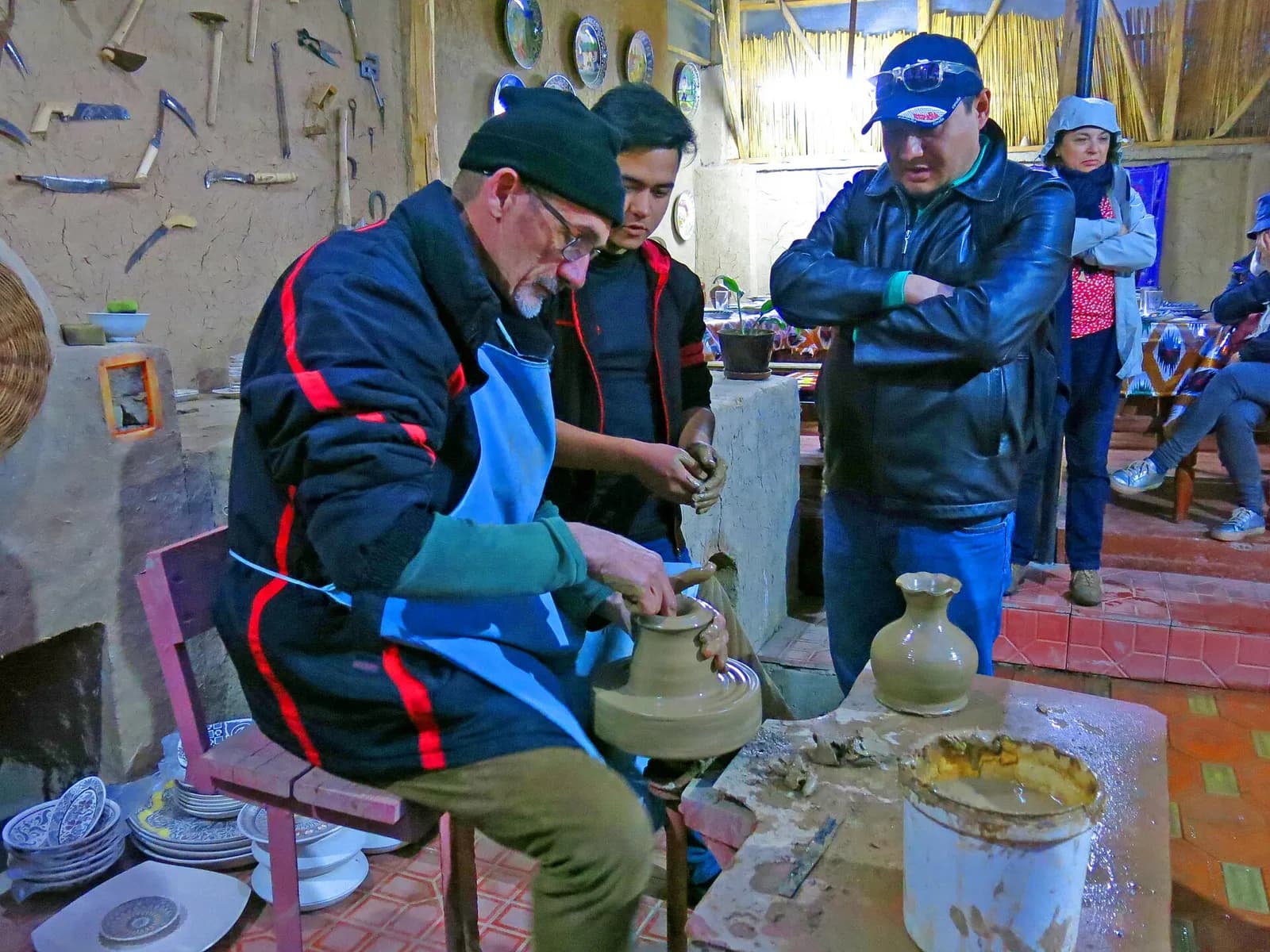 A potter at the wheel in a Rishtan ceramics workshop