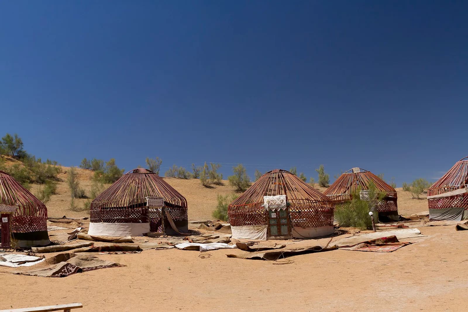 Yurts among the dunes at a camp near Aydarkul Lake