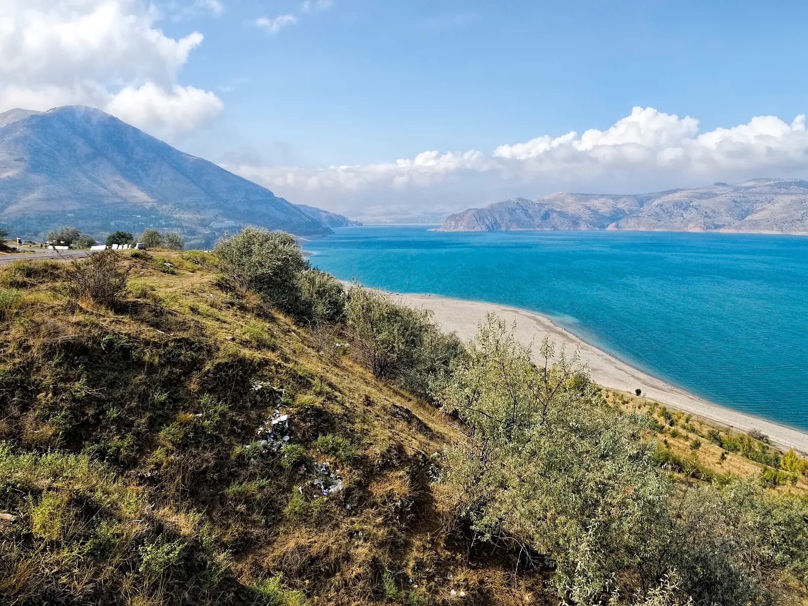 The turquoise Charvak Reservoir below the Chimgan Mountains
