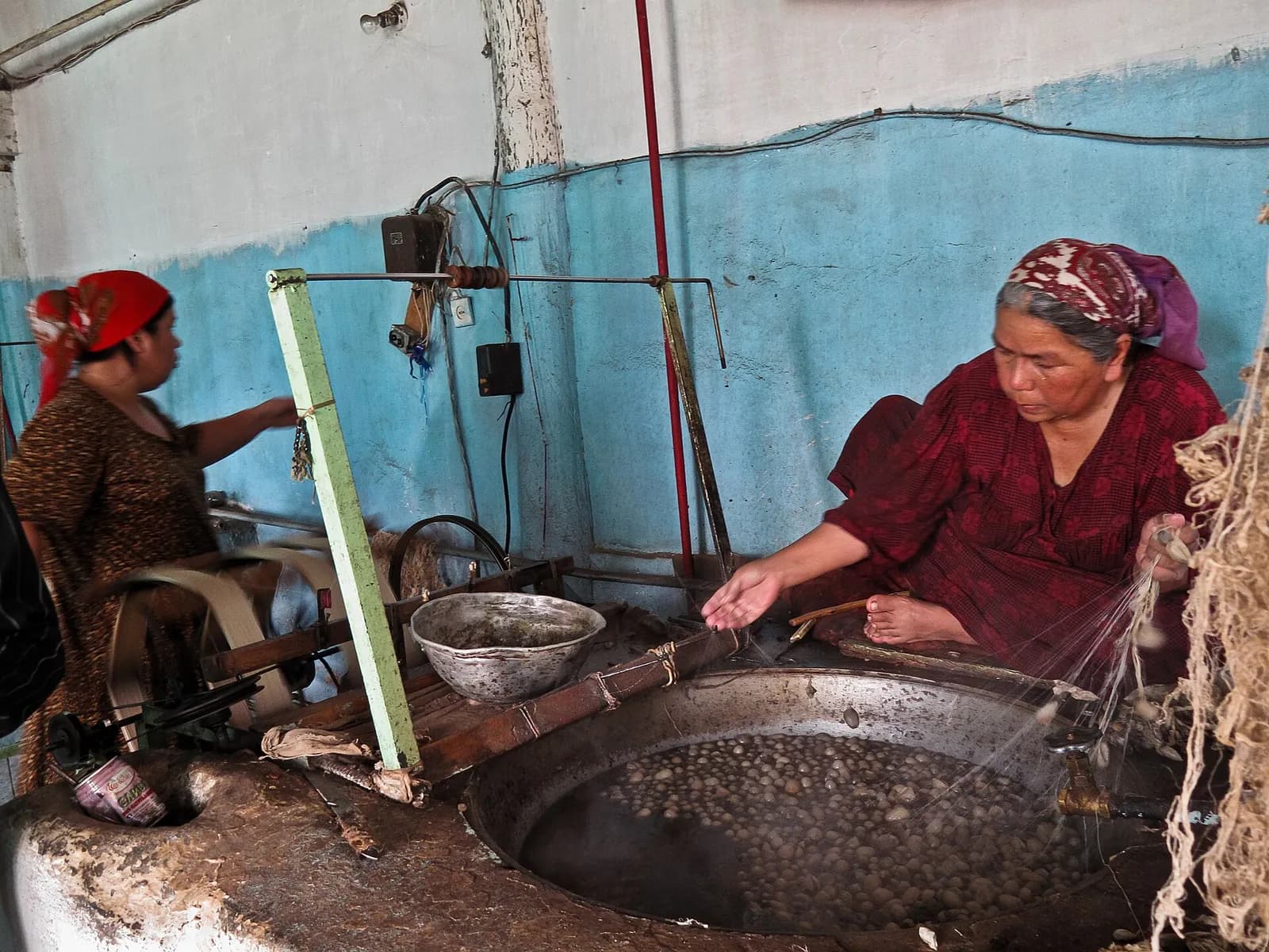 Unwinding silk from cocoons at the Yodgorlik silk factory, Margilan